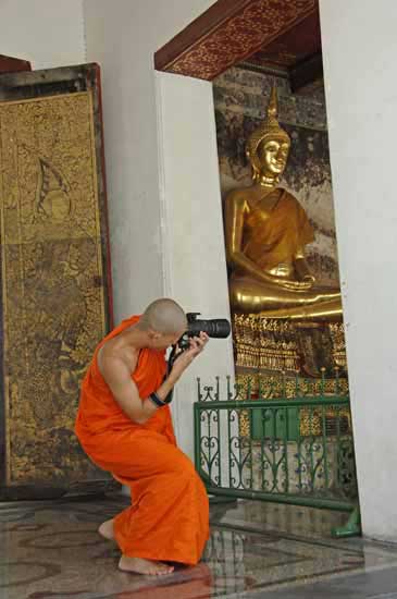 monk with camera-AsiaPhotoStock